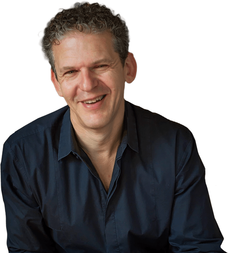 Russ harris smiling and wearing a grey collared shirt.