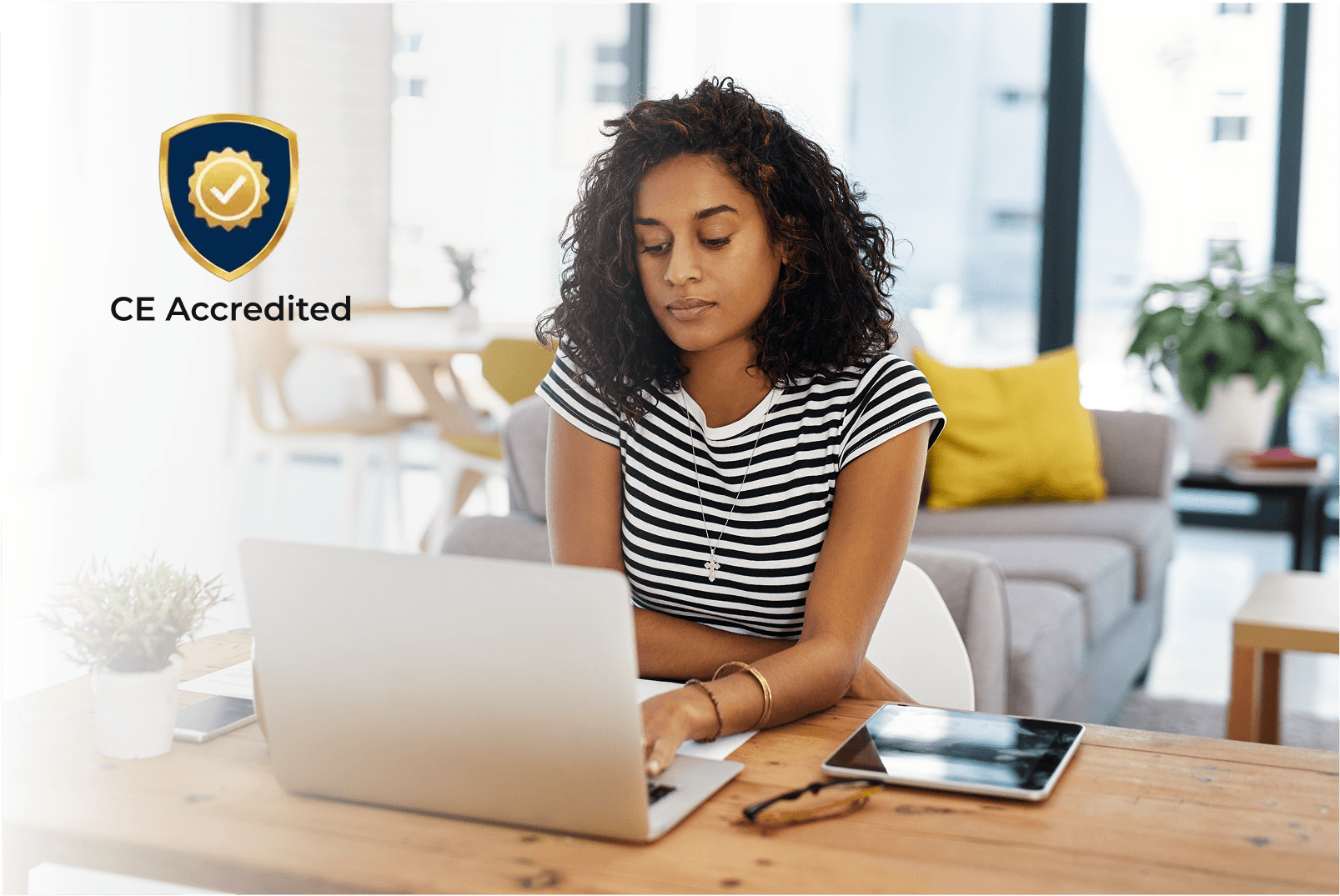 Woman at computer with CE Accreditation badge